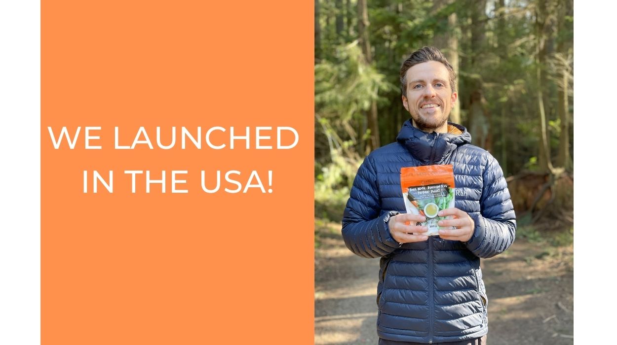 Connor MEakin with bone broth package in a forest
